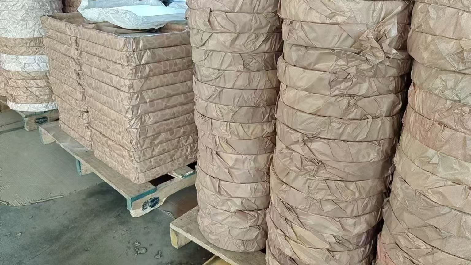 Wrapped aluminium lighting components on pallets at our partner workshop